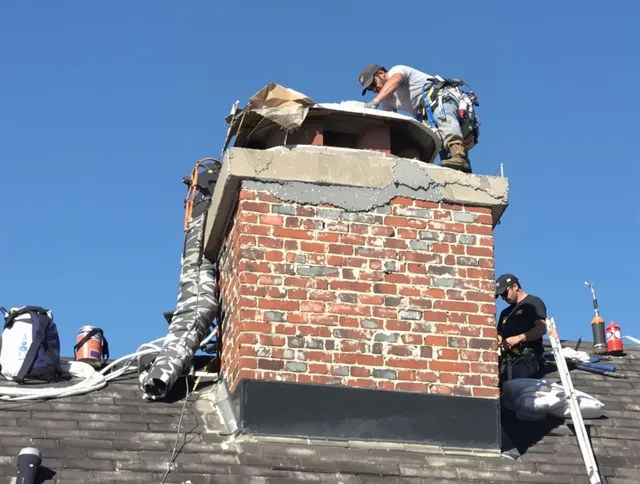Foxborough Chimney Sweep installing a custom chimney crown in Foxborough, MA