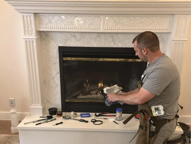 Foxborough Chimney Sweep performing fireplace maintenance in Foxborough, MA