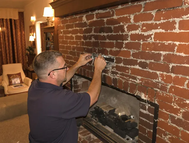 Foxborough Chimney Sweep expert fixing a fireplace in Foxborough, MA